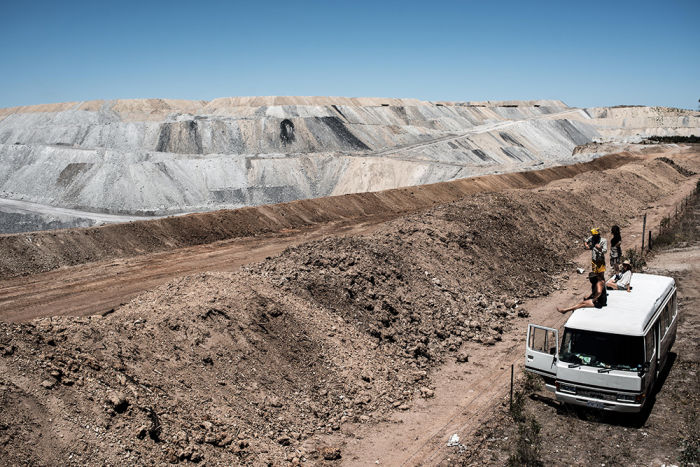 Caption: Surveying land ravaged by mining (Photo: Alex Moffatt)