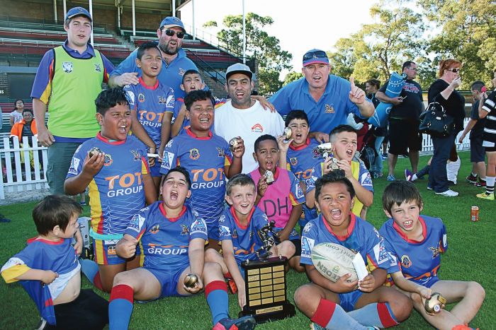 The victorious St Johns Eagles celebrate with Nathan Merritt (white T-shirt). Photo: Frank Trostel