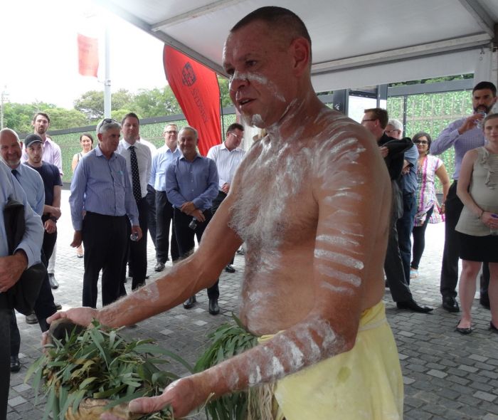 Terry Olsen conducts a smoking ceremony on campus. Photo: Supplied