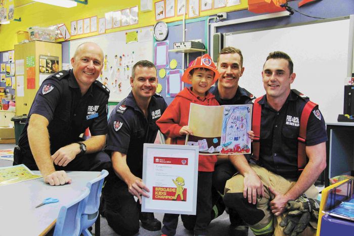 Oliver Kau with Newtown Station Officer Grant Moffit and fire fighters John McGirr, Mark Skuse and Jarod Mcgrouther  Photo: Lyn Turnbull