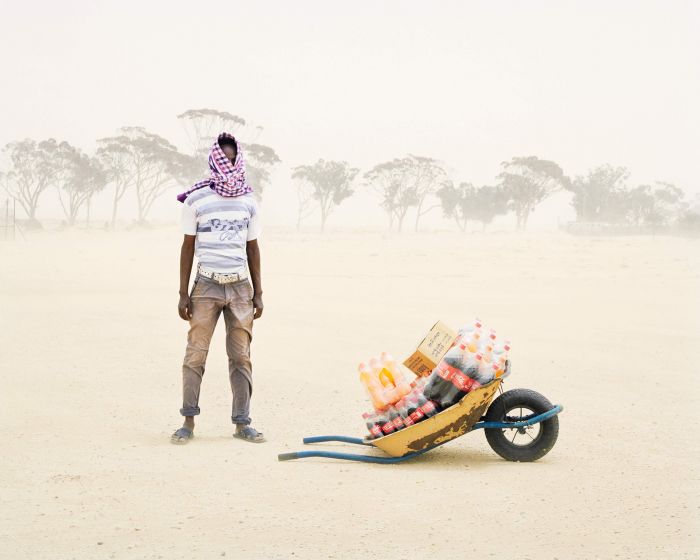 Severe sandstorms lash a man in Choucha refugee camp, Tunisia. Image: Samuel Gratacap, Empire, refugee camp of Choucha, Tunisia, 2012–14 (Courtesy of the artist and Gallery Les filles du calvaire, Paris)