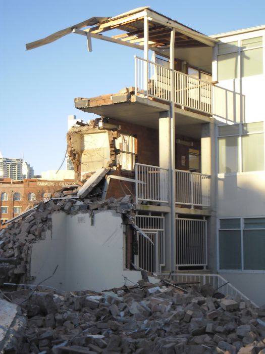 Demolition of buildings at Cowper St Glebe. Photo: Denis Doherty