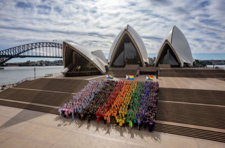 Sydneysiders create giant human progress flag to welcome WorldPride 2023